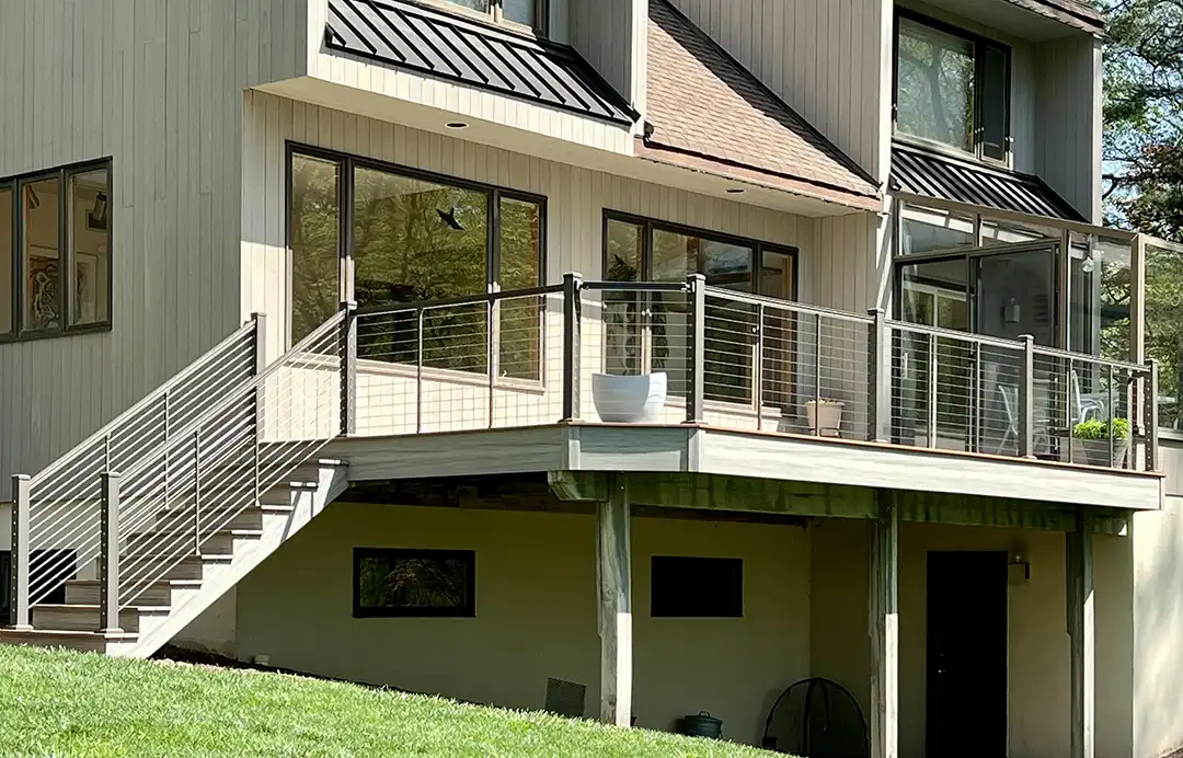 photo of an elevated composite deck with cable railing.