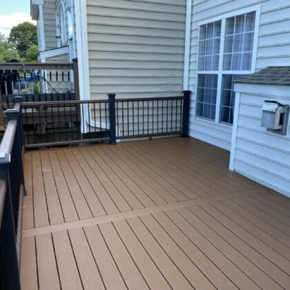 Photo of a composite deck with black metal railing