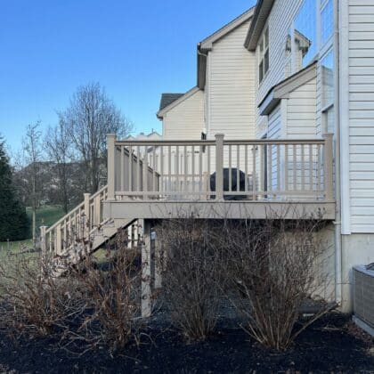 Photo of an elevated composite deck with railing and deck steps