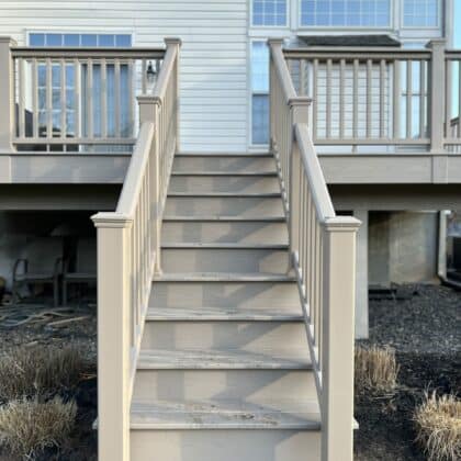 Photo of an elevated composite deck with railing and deck steps