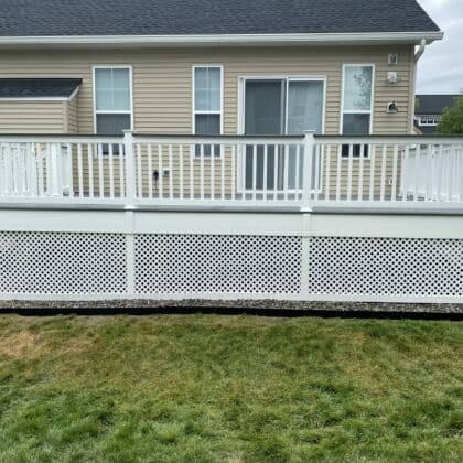 Front view of composite deck with white railing and white lattice work