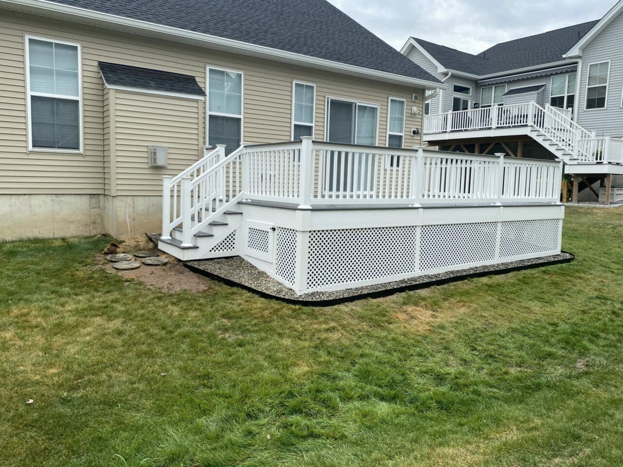 Photo of composite deck with white railing and white lattice work