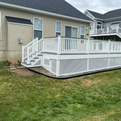 Photo of composite deck with white railing and white lattice work