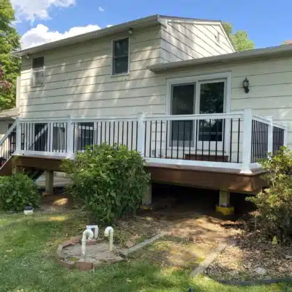 Custom Timbertech decking project with black vinyl railings and lighting - Deck building contractor near me in Doylestown PA