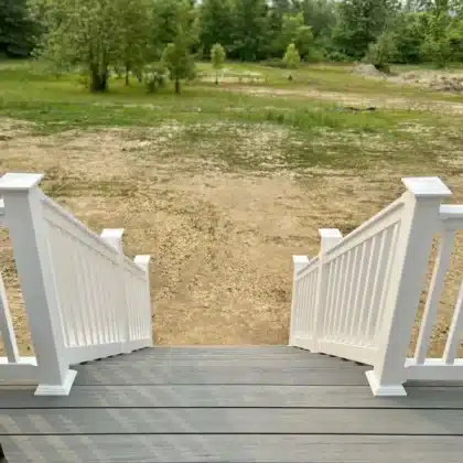 Elevated Composite Decking Project with timbertech stairs and white vinyl railings - Deck builders near me in Pipersville PA