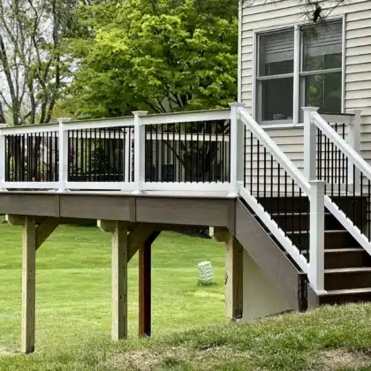 Elevated Timbertech Dark Cocoa deck with Black composite railings and stairs - Deck Building company near me in Maple Glen PA