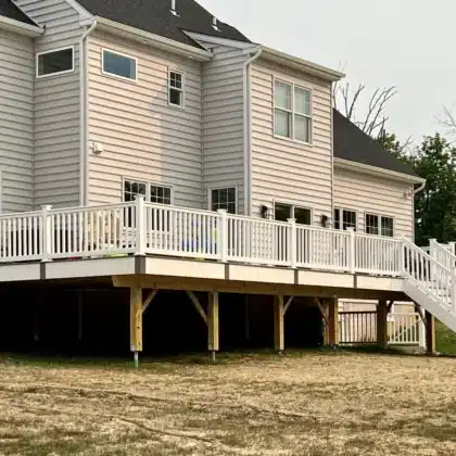 Finished Elevated Composite Decking Project with timbertech stairs and white vinyl railings - Deck builders near me in Pipersville PA