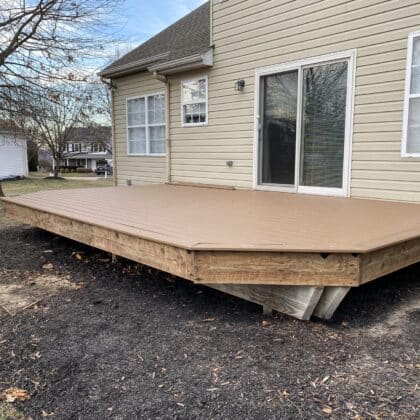 Photo of composite deck boards being installed on deck framing