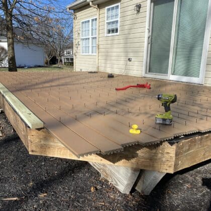 Photo of composite deck boards being installed on deck framing