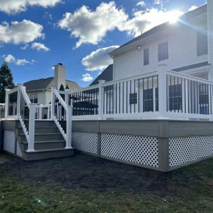 Photo of deck, white railing, black balusters