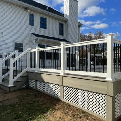 Photo of deck, white railing, black balusters, and deck steps