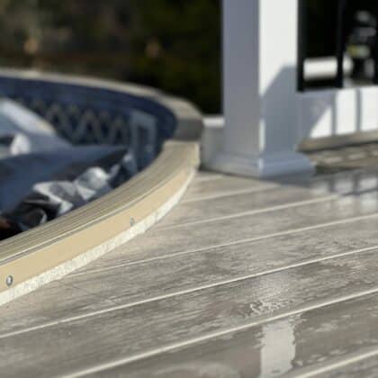 Close up of curved deck that touches pool side