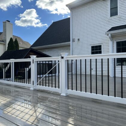 Photo of pool deck that is fenced and gated off from rest of deck