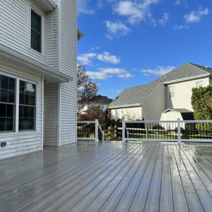 Photo of open deck, white deck railing and deck steps