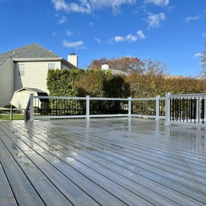 Open view of composite deck, white deck railing and deck steps