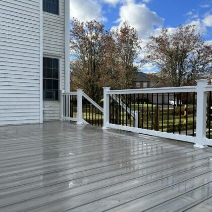 Photo of composite deck, white deck railing and deck steps