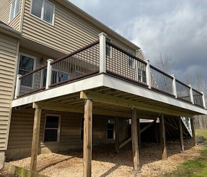 View of elevated deck with railing and steps