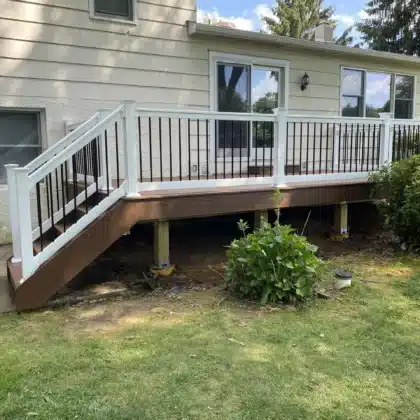 Timbertech decking project ideas with composite stairs and black vinyl railings - Deck builders near me in Doylestown PA