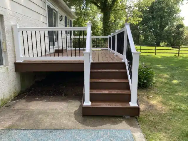 Timbertech decking project with composite stairs and black vinyl railings - Deck builders near me in Doylestown PA