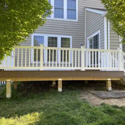 finished Timbertech decking project with white vinyl railings and lighting - Deck building company near me in Chester Springs PA