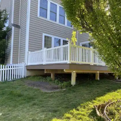 finished Timbertech decking project with white vinyl railings and lighting - Deck contractors in Chester Springs PA