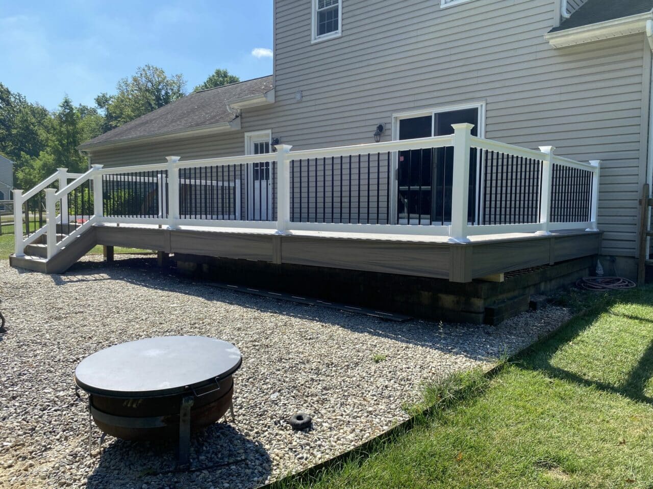 Photo of deck with white railing and balusters