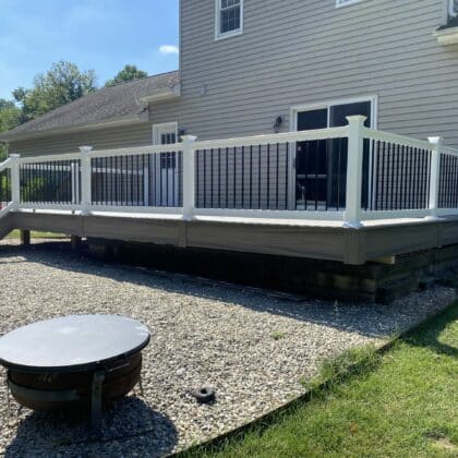 Photo of deck with white railing and balusters