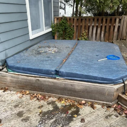 Photo of a hot tub on a deck that is going to be removed for a renovation project