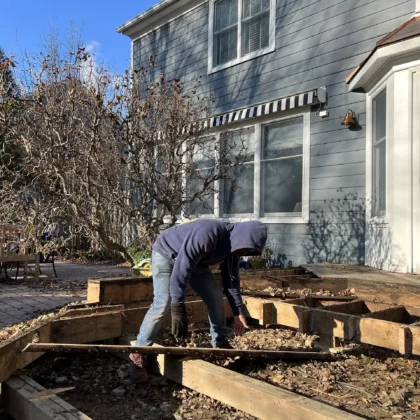 Photo of a deck crew in the process of removing an old deck for a renovation project