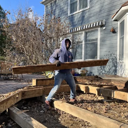 Photo of a deck crew in the process of removing an old deck for a renovation project