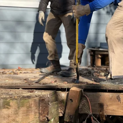 Photo of a deck crew removing deck boards for a renovation project