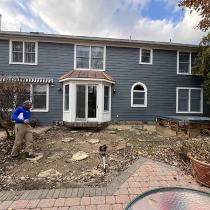 Photo of a deck crew in the process of removing an old deck for a renovation project