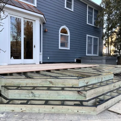 Photo of a cedar deck with steps and cedar railing being constructed