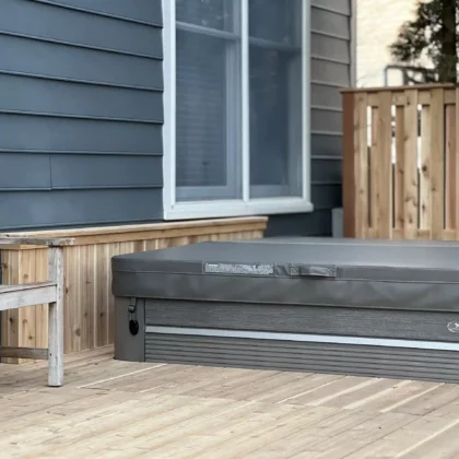 Photo of a cedar deck with railings and a hot tub