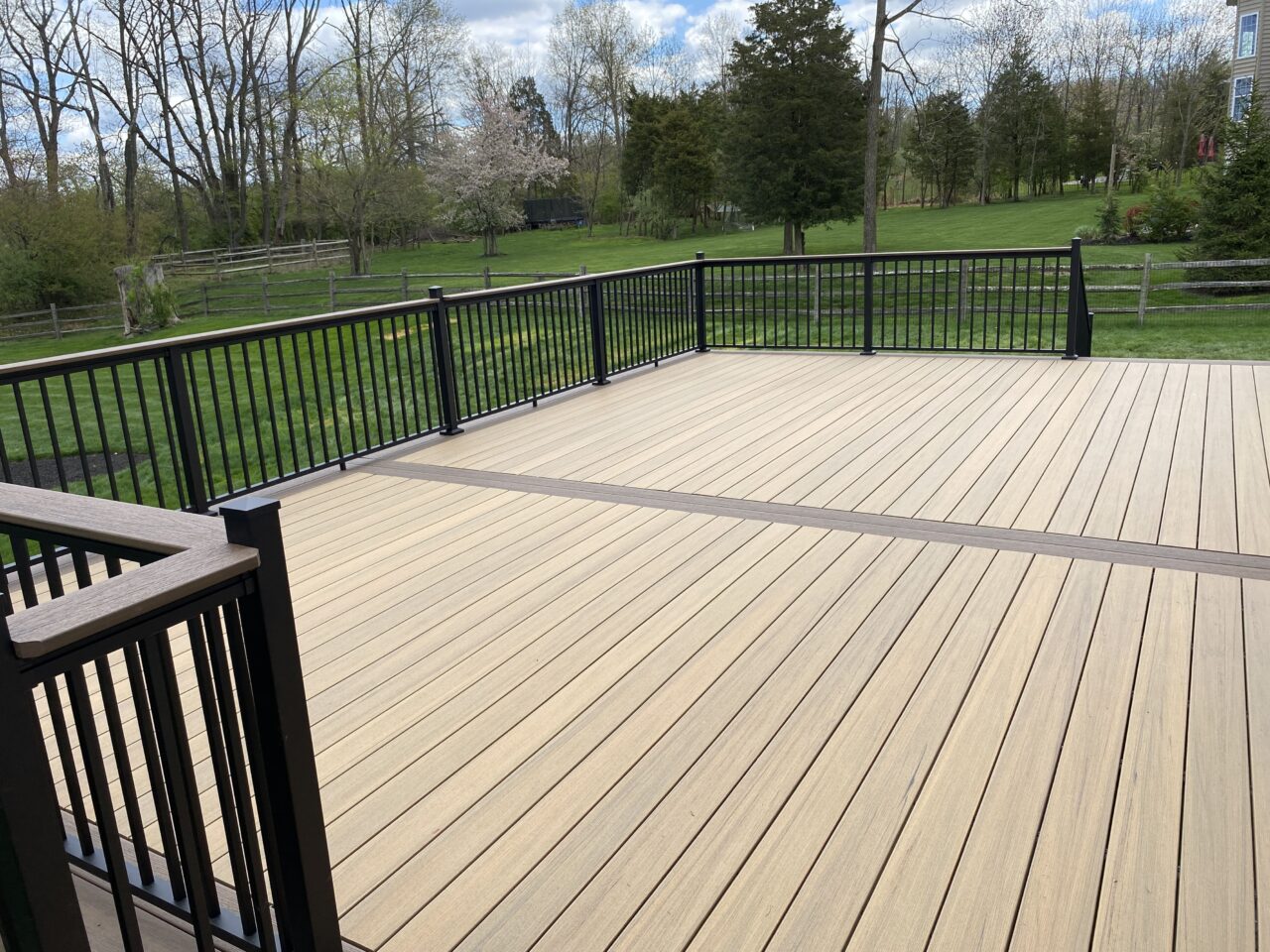 Photo of composite deck boards on a wide open deck with metal railing - Custom multi-level Deck builder and contractor Bucks & Montgomery County Pennsylvania