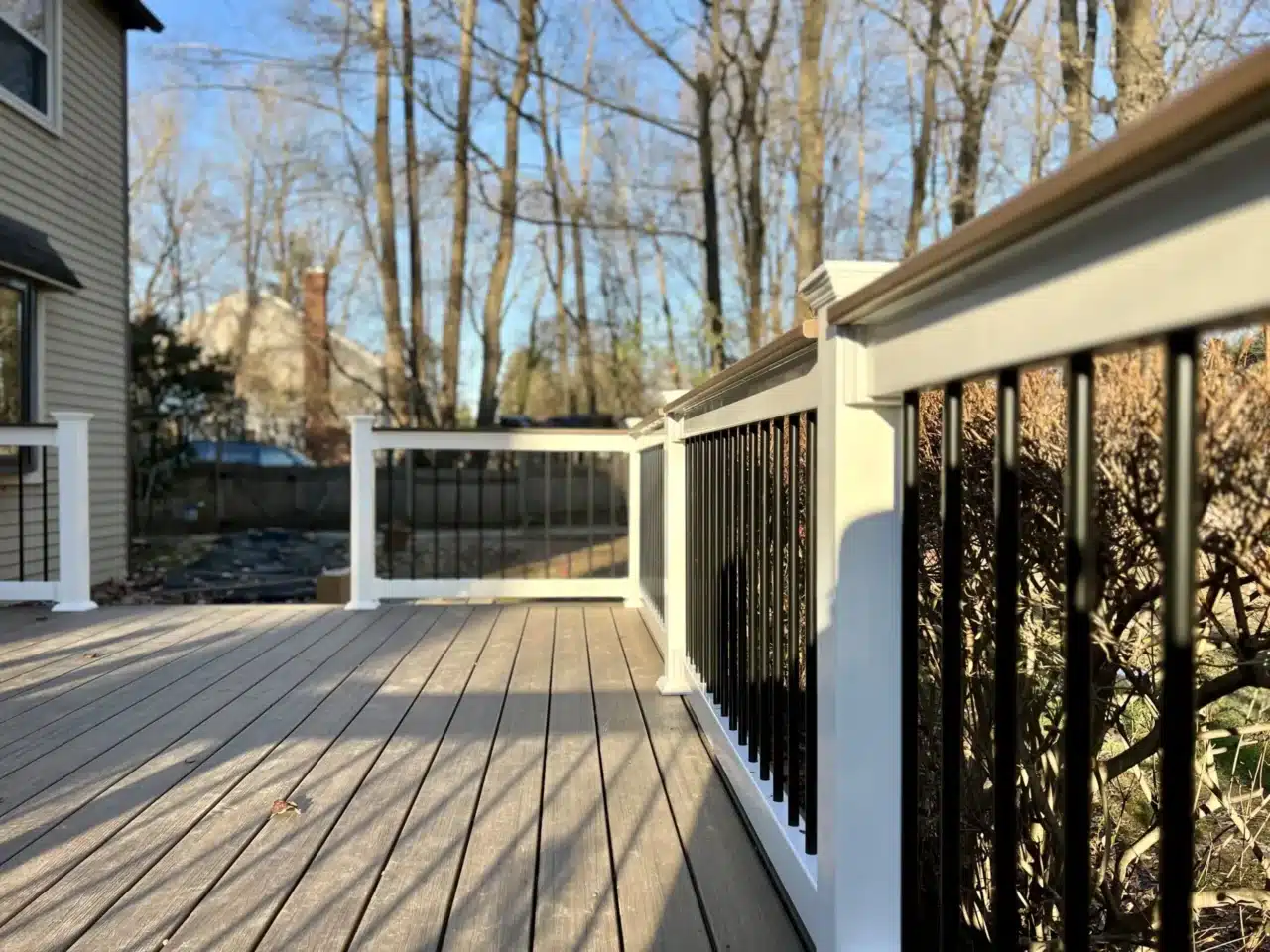 Custom deck with composite black railing - Deck railing contractors near me