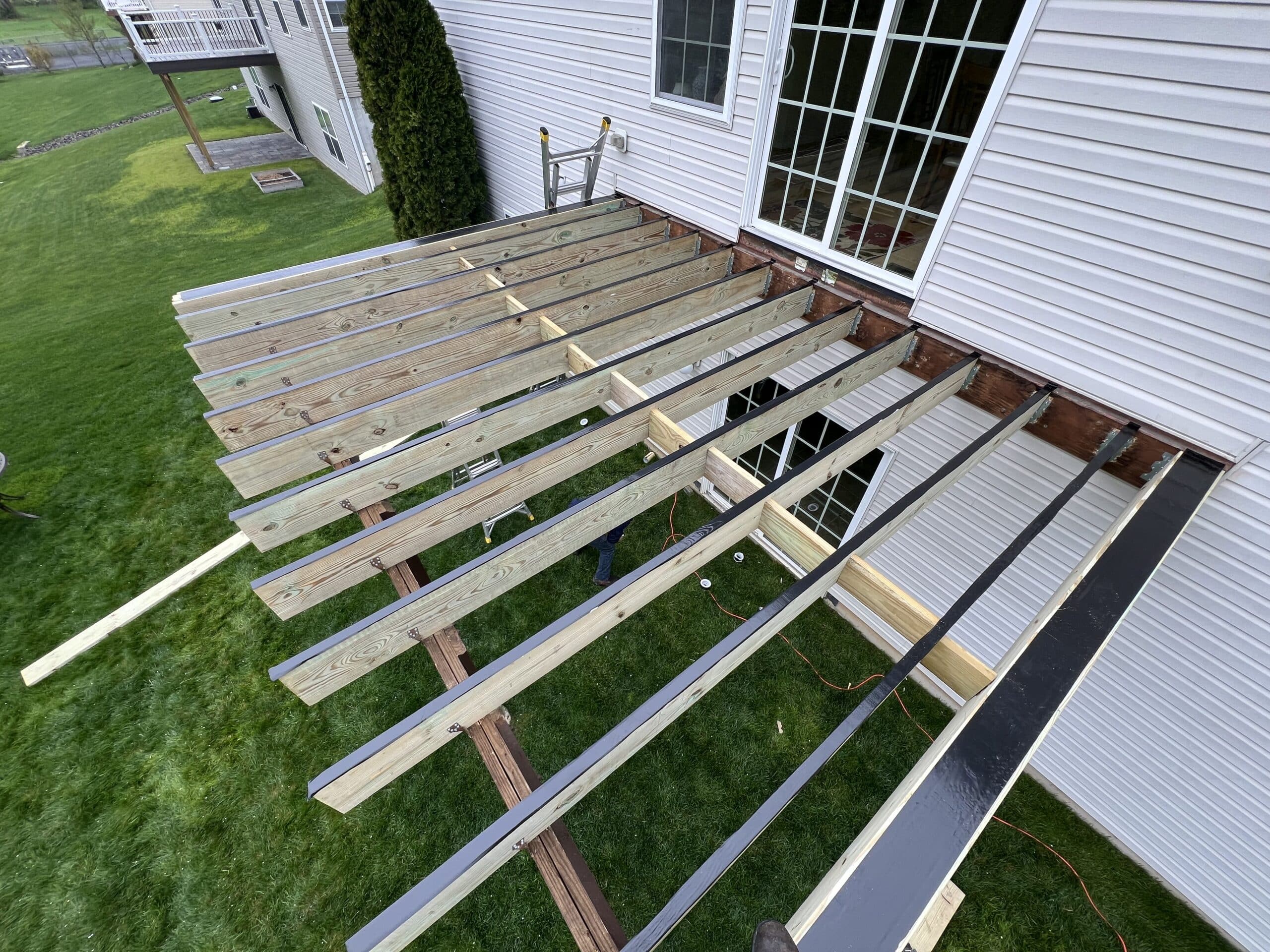 deck frame being constructed to local building codes