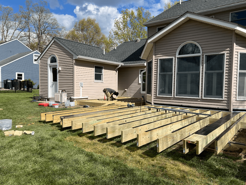 a new deck being build with wood deck framing by a professional deck builder