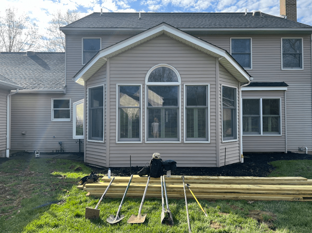 photo of construction materials and lumber at the site of a new deck build demonstrating why you should hire a professional deck contractor