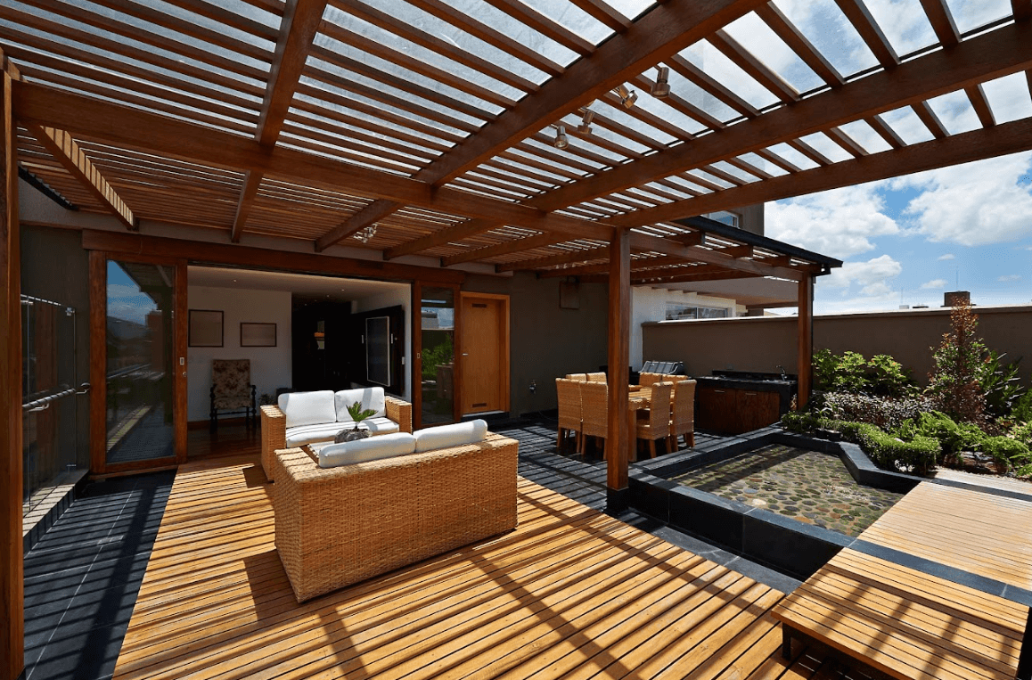 pergola provides cover for a multi-level deck with outdoor furniture - Rooftop Deck with pergola - Wooden pergola builder