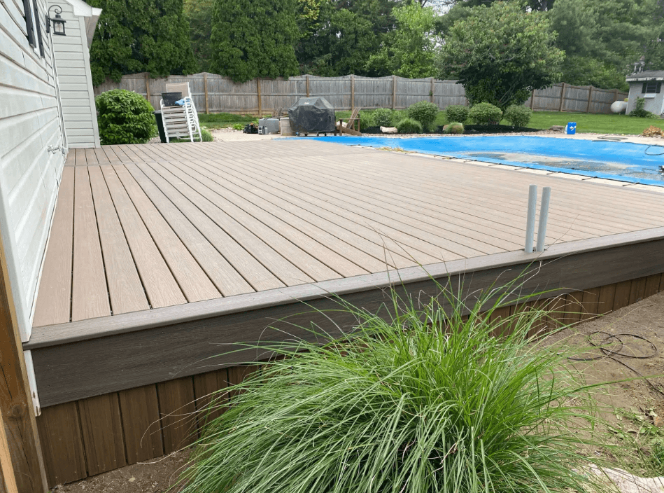 photo-of-a-composite-deck-with-an-in-ground-pool-with-a-concrete-deck - Pool deck resurfacing and construction services