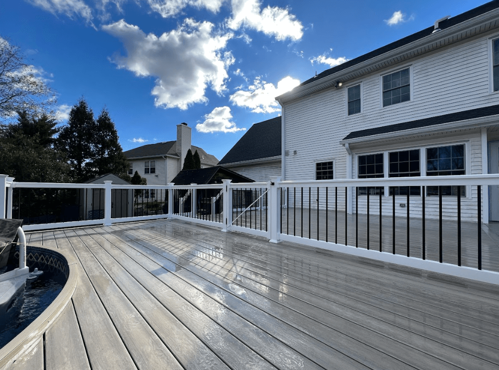 photo of pool deck that creates distinct zones by deck railing - Pool Deck Ideas for your outdoor living space